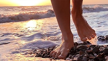 Bare feet walk on the sea waves
