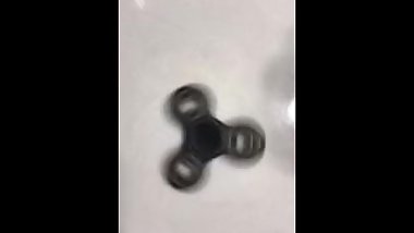 Sexy hand spins a fidget spinner