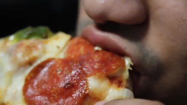 Hot stud eats pizza like there's no tomorrow